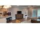 Inviting living room with kitchenette bar seating, media cabinet and a view into the bedroom at 1407 Gooseneck Place # 202, Murrells Inlet, SC 29576