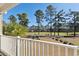 Scenic backyard view from a balcony overlooking the well-manicured lawn and lush trees, serene outdoor space at 1487 Lanterns Rest Rd. # 4, Myrtle Beach, SC 29579