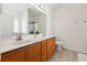 Bright bathroom features a double sink vanity with wooden cabinets and a large mirror at 1487 Lanterns Rest Rd. # 4, Myrtle Beach, SC 29579
