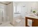 Bright bathroom features a tub with shower and white tiled floors at 1487 Lanterns Rest Rd. # 4, Myrtle Beach, SC 29579