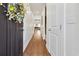 Hallway featuring wood floors, white trim, and a view leading into a naturally lit living space at 1487 Lanterns Rest Rd. # 4, Myrtle Beach, SC 29579