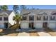 Inviting townhome featuring neutral-toned siding, black shutters, and well-manicured landscaping with a palm tree at 1487 Lanterns Rest Rd. # 4, Myrtle Beach, SC 29579