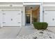 Charming entrance with stone accents, white garage doors, and well-maintained landscaping with decorative rocks at 1487 Lanterns Rest Rd. # 4, Myrtle Beach, SC 29579