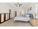 Bright main bedroom showcasing a tray ceiling, fan, and ensuite bathroom, offering space and serenity at 1487 Lanterns Rest Rd. # 4, Myrtle Beach, SC 29579
