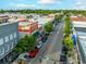 Aerial view of a downtown neighborhood with a blend of colorful buildings, tree-lined streets, and parked cars at 177 Fox Rae Dr., Conway, SC 29526