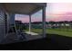 A relaxing back porch features rocking chairs, a tranquil pond view, and manicured lawns at 177 Fox Rae Dr., Conway, SC 29526