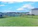 A spacious backyard features a lush lawn, rod iron fence, and a serene pond for scenic views at 177 Fox Rae Dr., Conway, SC 29526