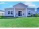 The backyard has a covered porch, rocking chairs, and a lush lawn, perfect for outdoor relaxation and enjoyment at 177 Fox Rae Dr., Conway, SC 29526