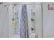 The bathroom has a shower with a curtain, shelves, and a stool at 177 Fox Rae Dr., Conway, SC 29526