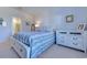 A well-lit primary bedroom featuring a comfortable bed, dresser and en-suite bathroom at 177 Fox Rae Dr., Conway, SC 29526