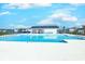 A large community swimming pool is surrounded by lounge chairs and umbrellas, offering a fun and relaxing space at 177 Fox Rae Dr., Conway, SC 29526