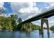 Picturesque waterfront scene featuring a large bridge over calm water, surrounded by green trees and a clear sky at 177 Fox Rae Dr., Conway, SC 29526