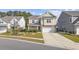 Inviting two-story home featuring neutral siding, stone accents, a well-manicured lawn, and an attached two-car garage at 1808 Zodiac Court, Myrtle Beach, SC 29577