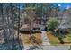 Charming single-story brick home with mature trees, an attached garage, and a long driveway, creating a welcoming curb appeal at 1917 Candy Ln., Surfside Beach, SC 29575