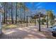 A spacious back deck with a pergola offers a relaxing outdoor living space surrounded by tall trees and shade at 1917 Candy Ln., Surfside Beach, SC 29575