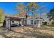 A spacious backyard with a deck, outdoor seating, and sunroom offers a place for outdoor living at 1917 Candy Ln., Surfside Beach, SC 29575