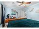 A bedroom with light blue walls and a ceiling fan, decorated with artwork and personal items at 1917 Candy Ln., Surfside Beach, SC 29575