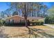 Charming brick home with a well-maintained lawn and mature trees at 1917 Candy Ln., Surfside Beach, SC 29575