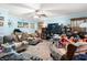 Comfortable living room with a ceiling fan, large TV, wood-look floors, and plush seating, creating a relaxing atmosphere at 1917 Candy Ln., Surfside Beach, SC 29575