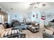 Spacious living room with comfortable seating, a ceiling fan, wood-look flooring, and decor, creating a lived-in space at 1917 Candy Ln., Surfside Beach, SC 29575