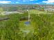 Drone shot showcases home surrounded by dense forest, highlighting privacy and seclusion at 1930 W Homewood Rd., Conway, SC 29526