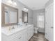 Large bathroom with dual sinks, white cabinets, decorative mirrors, and modern fixtures for a luxurious feel at 1930 W Homewood Rd., Conway, SC 29526