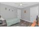 Cozy bedroom with wood-look floors, ceiling fan, and ample closet space, perfect for a or guest at 1930 W Homewood Rd., Conway, SC 29526