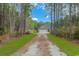 A charming home with a large front yard and driveway, nestled in a serene, wooded setting at 1930 W Homewood Rd., Conway, SC 29526