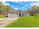 Charming single-story home with gray siding, well-manicured lawn, and attached two-car garage at 1930 W Homewood Rd., Conway, SC 29526