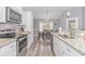 Modern kitchen with white cabinetry, stainless steel appliances, and granite countertops, overlooking the dining area at 1930 W Homewood Rd., Conway, SC 29526