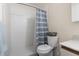 Bright bathroom featuring white tile shower and blue striped shower curtain at 2001 Spring St. # G-2, North Myrtle Beach, SC 29582