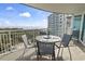 Balcony with outdoor dining set overlooking the ocean, trees, and a high-rise condo building at 215 77Th Ave. N # 413, Myrtle Beach, SC 29572