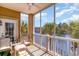 Screened-in balcony with tan seating and a view of the water surrounded by palm trees at 2180 Waterview Dr. # 727, North Myrtle Beach, SC 29582