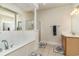 Bright bathroom featuring soaking tub with shower, glass-enclosed shower, and classic vanity at 2180 Waterview Dr. # 727, North Myrtle Beach, SC 29582