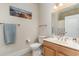 Bathroom features a single vanity, toilet, shower and a beautiful beach-themed wall print at 2180 Waterview Dr. # 727, North Myrtle Beach, SC 29582