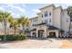 Beautiful condo exterior with a brick drive, palm trees, and a covered entrance leading into the building at 2180 Waterview Dr. # 727, North Myrtle Beach, SC 29582