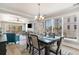 Open-concept dining room with seating for six, chandelier, and large windows with scenic views at 2180 Waterview Dr. # 727, North Myrtle Beach, SC 29582