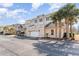 View of attached garage in a condo building with ample parking, a balcony, and palm tree landscaping at 2180 Waterview Dr. # 727, North Myrtle Beach, SC 29582