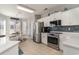 Charming kitchen with stainless steel appliances, tile backsplash, and an adjacent dining area flooded with light at 2180 Waterview Dr. # 727, North Myrtle Beach, SC 29582