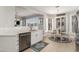 Open kitchen concept with stainless steel appliances, white cabinetry, and a view of a sunlit dining nook at 2180 Waterview Dr. # 727, North Myrtle Beach, SC 29582