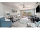Inviting living room featuring tray ceiling, ceiling fan, comfortable seating, and balcony access at 2180 Waterview Dr. # 727, North Myrtle Beach, SC 29582