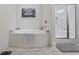Modern bathroom with a deep soaking tub, step in shower and gray tile flooring at 2794 Howard Ave. # D, Myrtle Beach, SC 29577