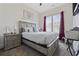 Comfortable bedroom with a ceiling fan, light wood bed frame, bedside table with lamp and stylish decor at 2794 Howard Ave. # D, Myrtle Beach, SC 29577
