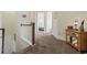 Upstairs hallway that leads to the bedrooms with neutral carpet and white trim at 2794 Howard Ave. # D, Myrtle Beach, SC 29577