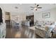 Open-concept living room features hardwood floors, a ceiling fan and flows into the kitchen and dining area at 2794 Howard Ave. # D, Myrtle Beach, SC 29577