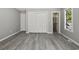 Bedroom with a large closet, window, and gray vinyl plank flooring at 306 74Th Ave. N # 105, Myrtle Beach, SC 29572