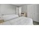 Comfortable bedroom with two twin beds, a woven bedside table, and a closet at 306 74Th Ave. N # 105, Myrtle Beach, SC 29572