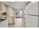 Spacious kitchen area featuring tile floors, ample cabinet space, and a sliding door to the outdoor patio for easy access at 306 74Th Ave. N # 105, Myrtle Beach, SC 29572