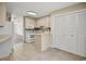 Bright and spacious kitchen with white appliances, tile flooring, and ample cabinet space for storage and organization at 306 74Th Ave. N # 105, Myrtle Beach, SC 29572