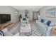Comfortable living room with light blue furniture, beach-themed decor, and a stylish rug for a relaxing atmosphere at 306 74Th Ave. N # 105, Myrtle Beach, SC 29572